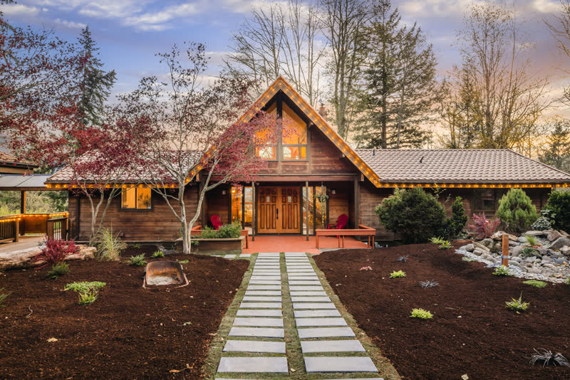 A-frame home exterior with new landscaping and twilight lighting in Washougal, Washington